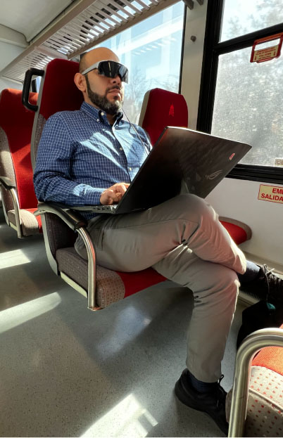 Man working on laptop in train